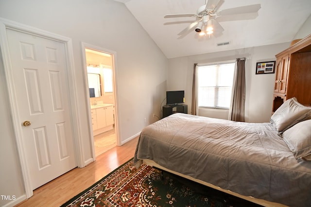 bedroom with lofted ceiling, connected bathroom, ceiling fan, and light wood-type flooring