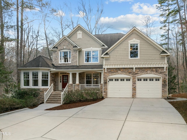 craftsman house with covered porch, driveway, a shingled roof, and a garage