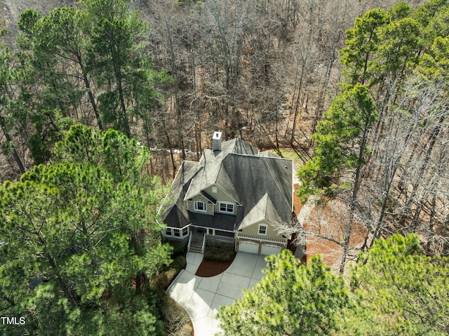 birds eye view of property with a forest view