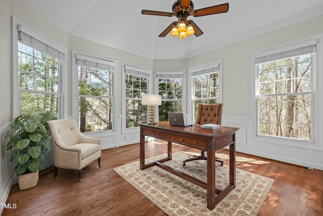 office space with lofted ceiling, a healthy amount of sunlight, and wood finished floors