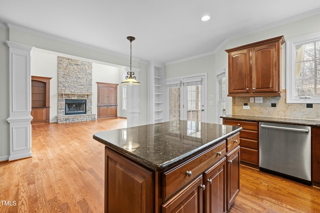 kitchen with light wood-style flooring, ornamental molding, tasteful backsplash, a fireplace, and dishwasher