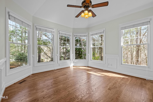 unfurnished sunroom featuring visible vents, lofted ceiling, and ceiling fan