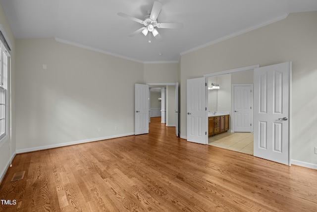 unfurnished bedroom featuring visible vents, baseboards, crown molding, and light wood-style floors