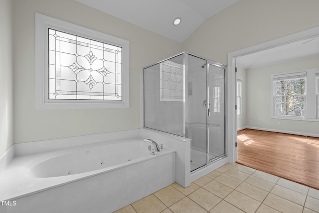 bathroom with tile patterned flooring, a stall shower, a jetted tub, and lofted ceiling