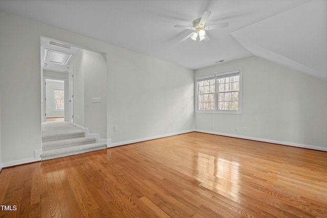 bonus room with wood-type flooring, plenty of natural light, and vaulted ceiling