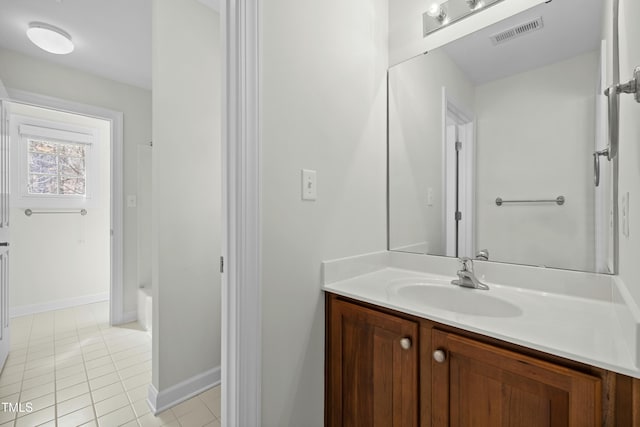 bathroom with tile patterned floors, visible vents, baseboards, and vanity