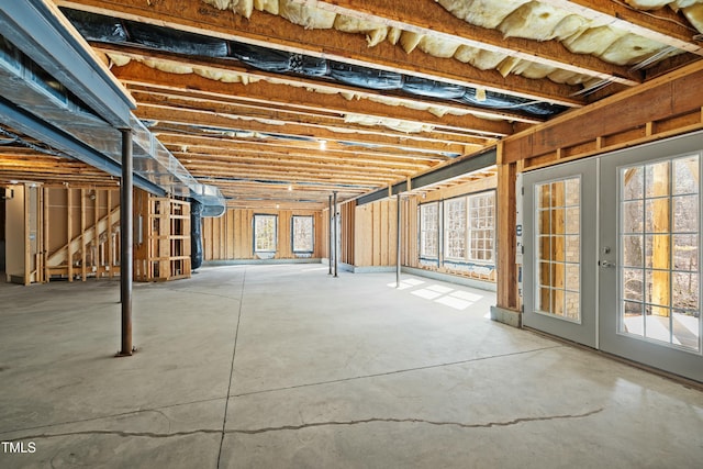 basement featuring a healthy amount of sunlight and french doors