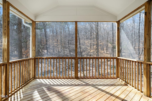 unfurnished sunroom featuring vaulted ceiling