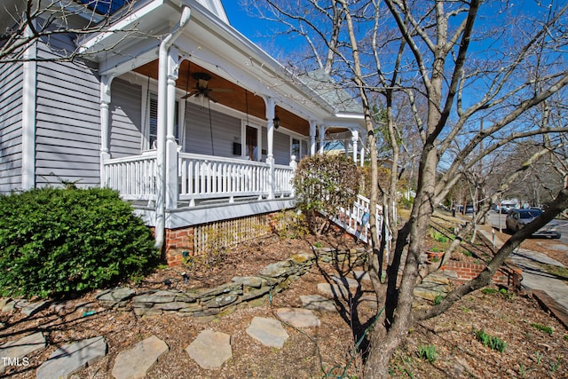 view of home's exterior with a ceiling fan and covered porch