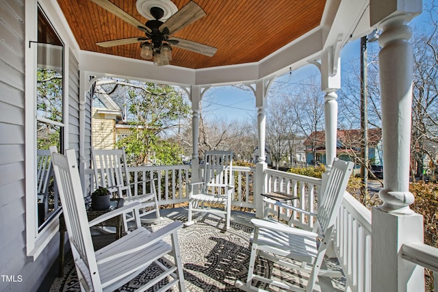 deck with ceiling fan and covered porch