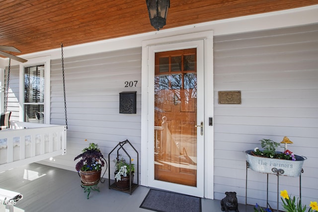 view of exterior entry with a porch