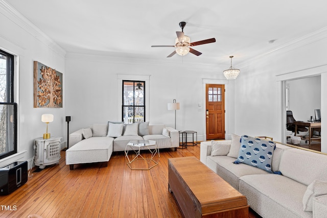 living area featuring crown molding, ceiling fan, and hardwood / wood-style floors