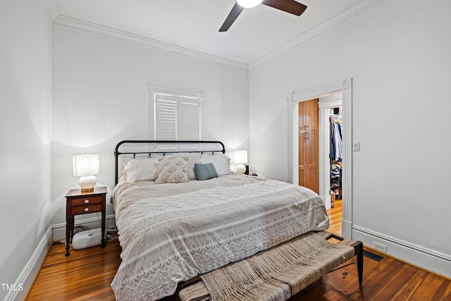 bedroom featuring ornamental molding, hardwood / wood-style flooring, and baseboards