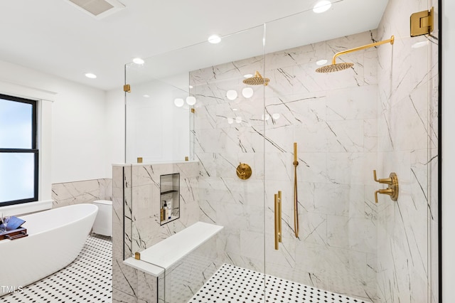 full bath featuring a soaking tub, visible vents, tile walls, and a marble finish shower