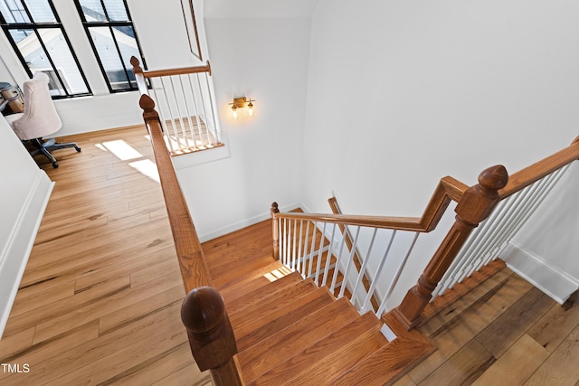 stairway with hardwood / wood-style flooring and baseboards