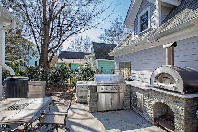 view of patio featuring outdoor dining space, a grill, and area for grilling