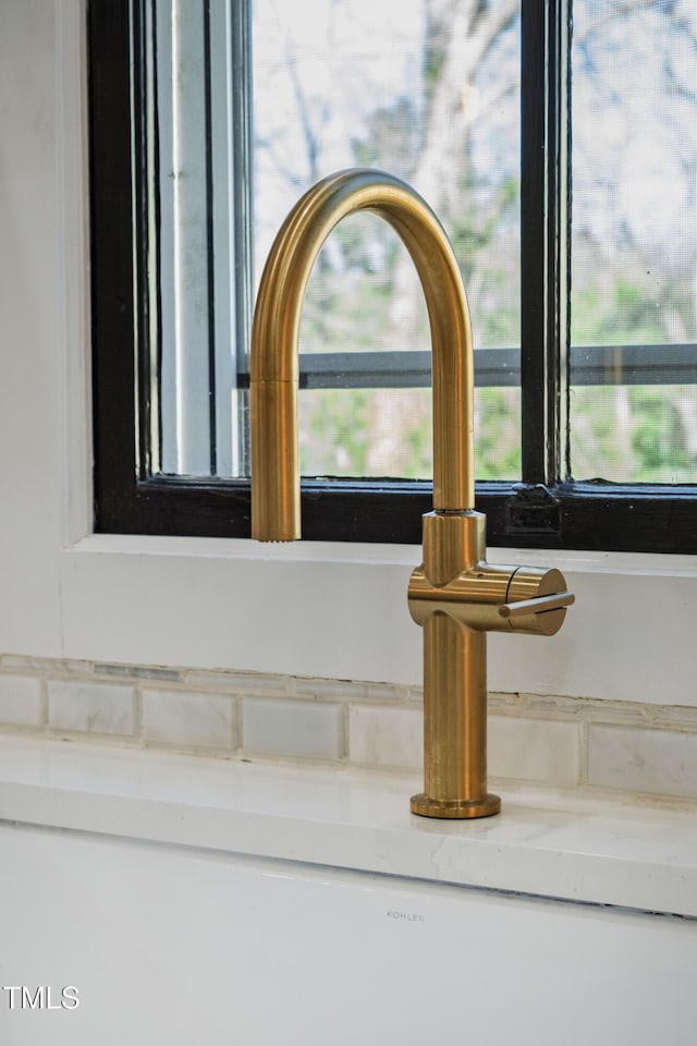 interior details featuring a sink and light stone countertops