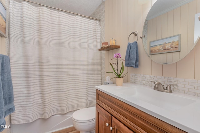 full bathroom with vanity, shower / tub combo, and toilet