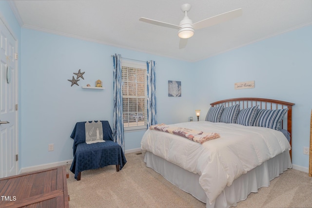 carpeted bedroom with crown molding and ceiling fan