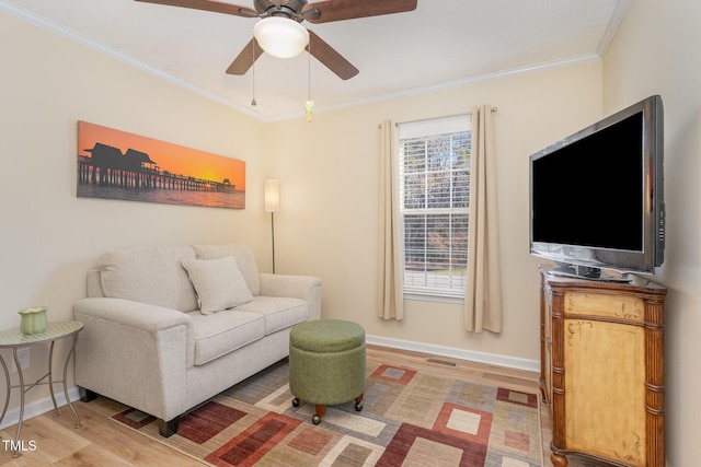 living room with crown molding, ceiling fan, a healthy amount of sunlight, and wood-type flooring