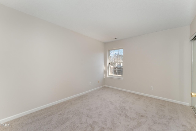 unfurnished room with light colored carpet