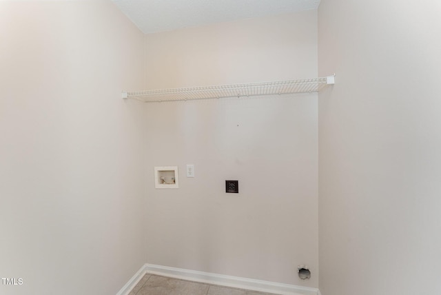 washroom featuring light tile patterned floors, hookup for a washing machine, and hookup for an electric dryer