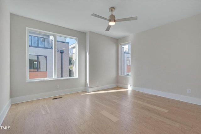 unfurnished room featuring ceiling fan and light wood-type flooring