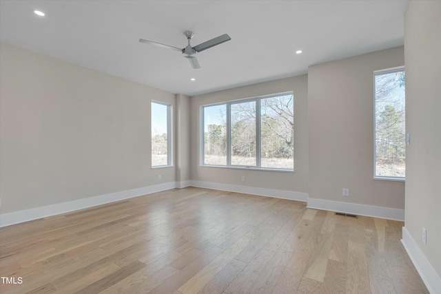 empty room featuring ceiling fan and light hardwood / wood-style flooring