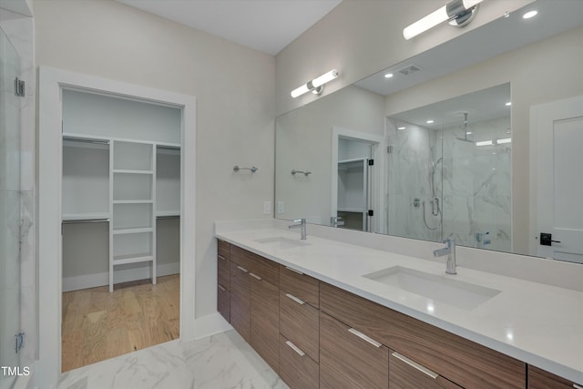 bathroom featuring vanity, an enclosed shower, and hardwood / wood-style floors