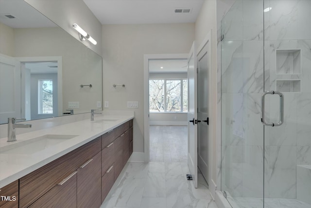 bathroom featuring an enclosed shower and vanity