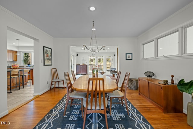 dining space featuring recessed lighting, light wood-type flooring, baseboards, and ornamental molding