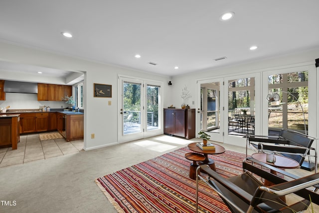 interior space with recessed lighting, visible vents, light carpet, and ornamental molding