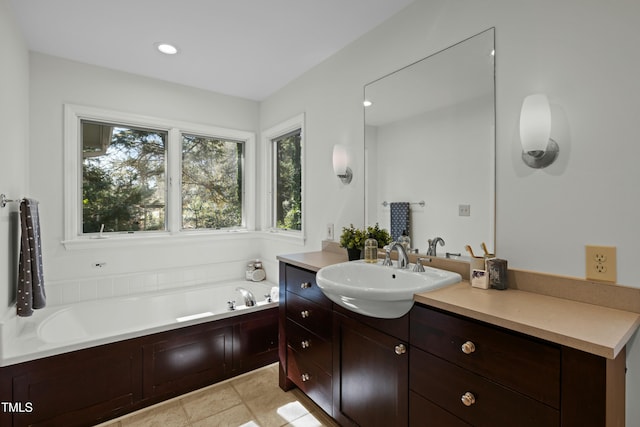 full bathroom featuring recessed lighting, a bath, and vanity