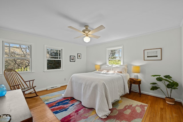 bedroom featuring visible vents, baseboards, and hardwood / wood-style flooring