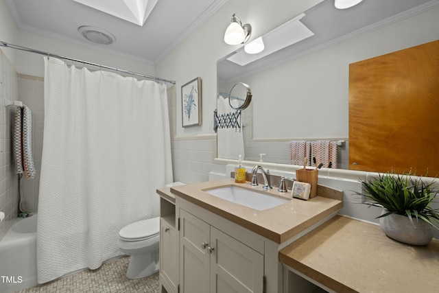 full bathroom with toilet, tile walls, vanity, and ornamental molding