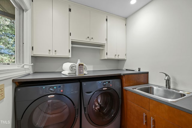 washroom with a sink, cabinet space, washing machine and dryer, and recessed lighting