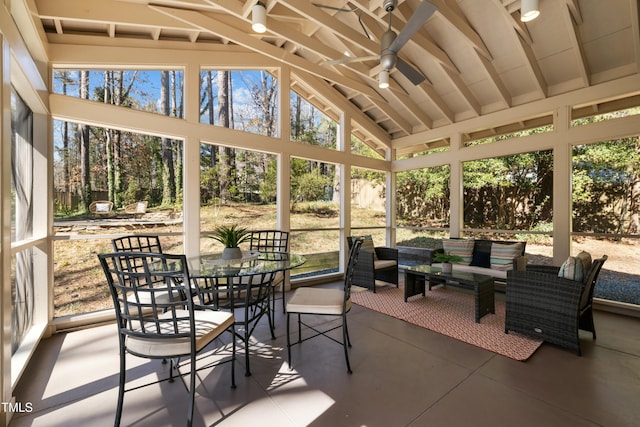 sunroom / solarium featuring lofted ceiling and ceiling fan