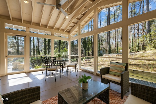 sunroom / solarium featuring ceiling fan and vaulted ceiling with beams