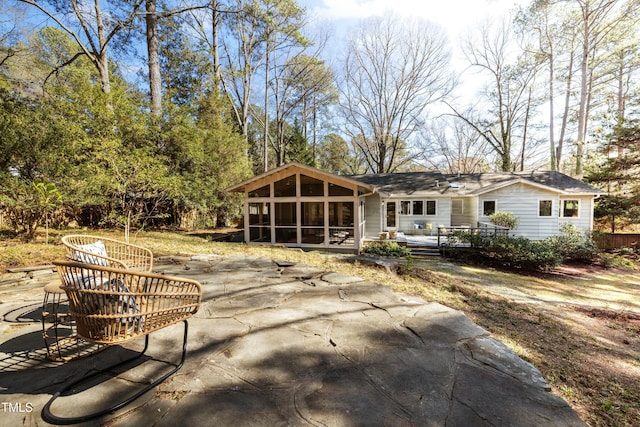 back of property featuring a patio and a sunroom