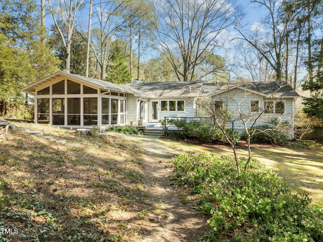 back of property with a sunroom