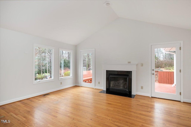 unfurnished living room with lofted ceiling and light hardwood / wood-style floors