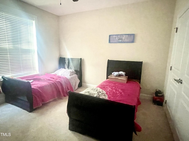 bedroom featuring light carpet and ceiling fan