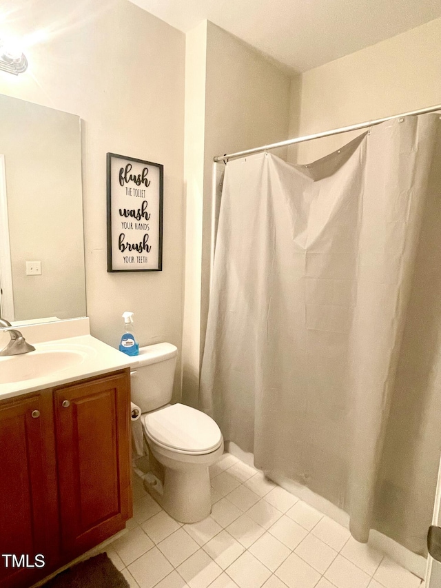 bathroom featuring tile patterned floors, vanity, and toilet