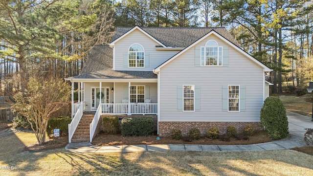 view of front of home with covered porch and a front yard