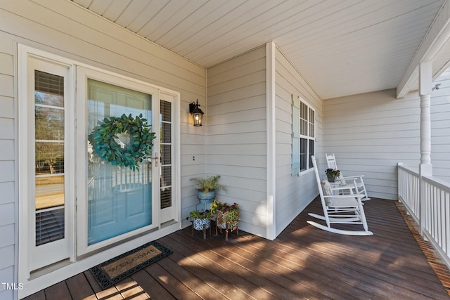 wooden terrace featuring covered porch