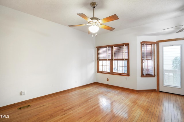 spare room featuring a textured ceiling, light hardwood / wood-style floors, and ceiling fan