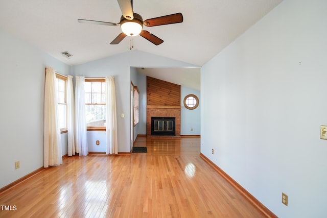 unfurnished living room featuring a brick fireplace, wood-type flooring, ceiling fan, and vaulted ceiling