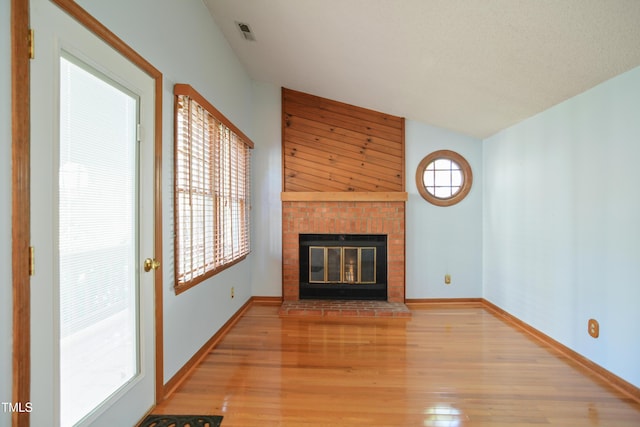 unfurnished living room with a fireplace and light hardwood / wood-style floors