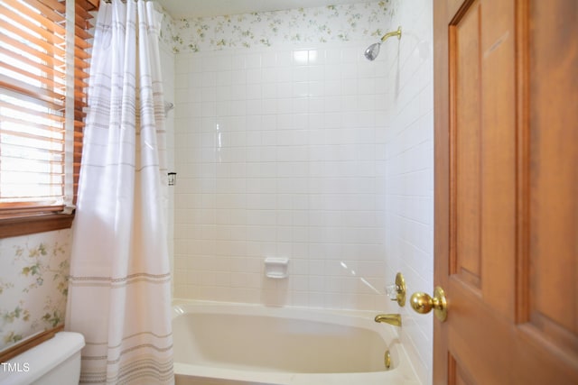 bathroom with shower / bath combo and toilet