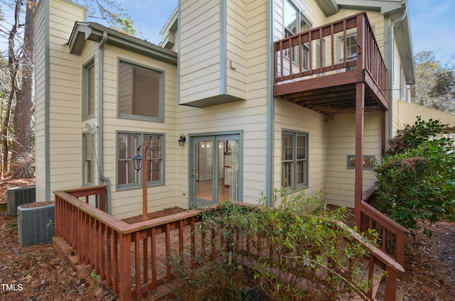 rear view of house featuring central AC and a balcony